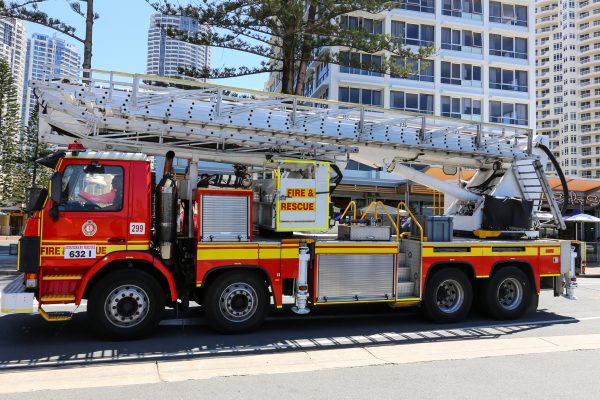 Gold Coast, Australia - October 7, 2016: Modern red fire and rescue truck with ladder in the streets of Surfers Paradise.